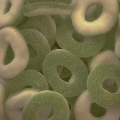 green and white donuts are stacked together