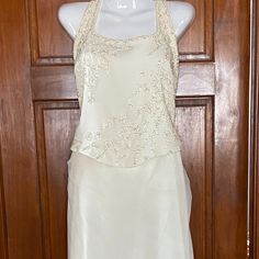 Pronovias Cream 2 Piece Halter Wedding Dress Hand Beaded Bodice Skirt Has Multiple Layers Top And Bottom Fully Lined Easy To Move Around In Size 14 Skirt Needs To Be Dry Cleaned Elegant Silk Mother Of The Bride Dress For Wedding, Elegant Silk Mother Of The Bride Dress, Elegant Satin Mother Of The Bride Dress For Wedding, Champagne Silk Evening Dress For Wedding, Silk Wedding Dress With Fitted Bodice For Evening, Elegant Silk Wedding Dress With Fitted Bodice, Elegant Floor-length Wedding Dress For Ceremony, Silk Wedding Dress With Sweep Train, Elegant Cream Gown For Wedding Night