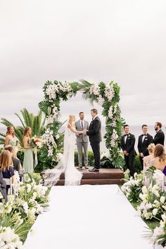 a bride and groom standing at the end of their wedding ceremony