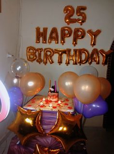 the birthday cake is surrounded by balloons and streamers that spell out 25 happy birthday