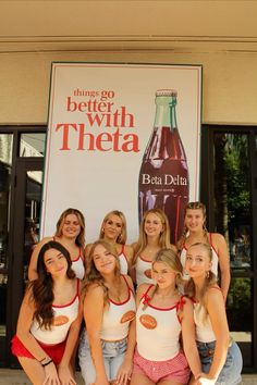 a group of women posing for a photo in front of a beer bottle sign with the caption, things go better with them