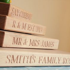 three wooden books stacked on top of each other with the words mr and mrs engraved on them