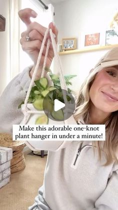 a woman holding up a plant in front of her face with the caption make this adorable one - knot plant hanger under a minute