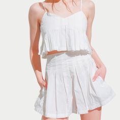 The Alaia Set is a perfect blend of elegance and versatility, designed for effortless summer style. Featuring a pleated cami and matching high-waisted shorts, this coordinated look offers both comfort and sophistication for any occasion. Summer Tops With Built-in Bra, Short Length, Cotton Camisole Bottoms For Summer, Chic Cotton Bottoms With Adjustable Straps, Chic Cotton Camisole With Tie Back, Fitted Bottoms With Smocked Back For Summer, Summer Bottoms With Adjustable Straps For Day Out, Casual Fitted Bottoms With Tie Back, Summer Cami Bottoms With Adjustable Straps, Chic Smocked Back Bottoms For Summer