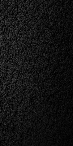 a black textured wall is shown in this image