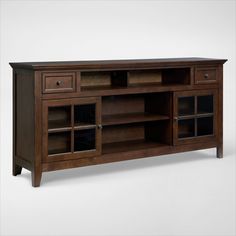 a wooden entertainment center with glass doors on the front and bottom shelves in dark wood