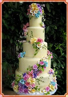 a multi layer cake with flowers on it