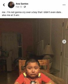 a young boy sitting at a table in front of a plate with food on it