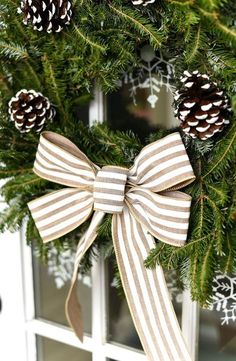 a close up of a wreath with pine cones