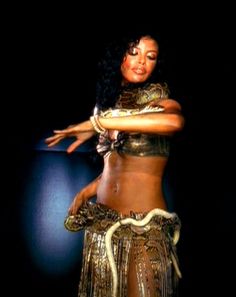 a woman in a belly dance pose with her arms outstretched and hands out to the side