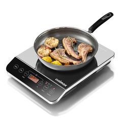 a frying pan filled with meat and vegetables on top of an electric burner