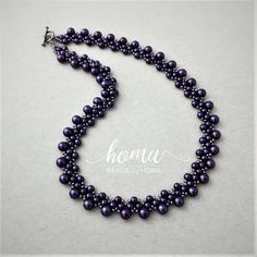 Elegant handmade woven necklace made of seed beads, beautiful shiny dark purple imitation pearls and a metal toggle clasp, with a dazzling appearance suitable for bridal, special occasions or everyday use.  Length of the necklace is 17 inches and it weighs 24 grams.  One branded jewellery box is included. About the Design:  I have designed and handcrafted this necklace and created it in my little home studio in Calgary, Alberta, Canada. It has a unique style and would make a great addition to an Elegant Purple Jewelry With Tiny Beads, Elegant Purple Beaded Necklace With Round Beads, Handmade Purple Beaded Necklace For Weddings, Purple Tiny Beads Party Jewelry, Elegant Purple Round Beaded Necklaces, Handmade Purple Pearl Necklace With Round Beads, Elegant Purple Beads For Party, Purple Round Beads Pearl Necklace For Gift, Purple Beaded Pearl Necklace