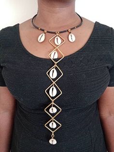 A Set of  African Cowrie Jewelry, Handmade Necklace, Seashell Jewelry, Boho Necklace, One size fits all, Pendant Necklace, EarringsThis set of jewelry is made of brass and cowrie seashell. It will make you stand out in any occasion.Necklace can fit any neck size..This can be a perfect gift for your loved ones. The price is inclusive of one necklace and a pair of matching earrings.We offer wholesale at a fair price,please contact me.***Free shipping on additional items in your cart.*** ***For mor Beaded Metal Necklaces For Beach, Shell Choker Jewelry As A Gift, Shell Choker Jewelry Gift, Gold Beaded Shell-shaped Jewelry, Beaded Cowrie Shell Jewelry For Gift, Cowrie Shell Dangle Jewelry For Gifts, Cowrie Shell Dangle Jewelry Gift, Handmade Adjustable Shell Jewelry, Gold Cowrie Shell Jewelry For Gift