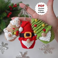 two crocheted christmas ornaments are being held in someone's hand