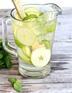 a pitcher filled with sliced cucumbers and mint