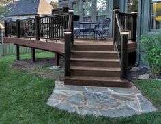 a deck with steps leading up to a house