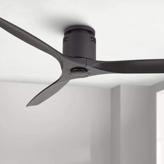 a black ceiling fan in a white room