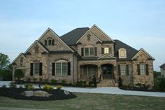 a large brick house with lots of windows