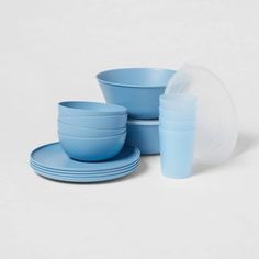 blue dishes and cups are stacked on top of each other