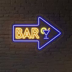 Enhance the ambiance of your establishment with this Crazy Neon LED sign. Perfect for a variety of settings including restaurants, bars, hotels, and event venues, this eye-catching sign is sure to draw attention and create a vibrant atmosphere. The captivating design features the word "Bar" in bright yellow, accompanied by a cocktail glass symbol, all housed within a large blue arrow. This striking and modern addition to your space adds a pop of color and personality, making it a must-have for a Blue Arrow, Right Arrow, Neon Led Sign, Restaurant Signs, Modern Addition, Led Bar, Led Sign, Bar Sign, Cocktail Glass