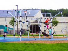 children playing on the playground equipment in front of a building