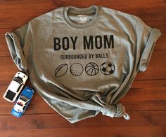 BOY MOM  SURROUNDED BY BALLS Gildan Military Green T-Shirt Soft Lightweight Shirt Unisex Sizing 50% Cotton 50% Polyester Machine Washable Available in S, M, L, XL Shirts are made to order to please do not hesitate to message me with questions or requests!! Boy Mom Shirt, Sporty Mom, Morristown Nj, Womens Graphic Tees, Mom Of Boys Shirt, Sports Shirt, Green T Shirt, Soccer Mom, Green Tshirt