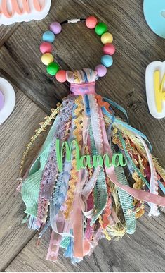 a colorful bracelet with name on it sitting next to some candy and other items in the background