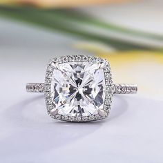 a cushion cut diamond surrounded by pave set diamonds