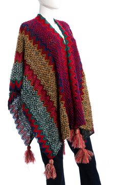 Layer up in this cotton-blend poncho knit with vibrant zigzags and finished with playfully oversized tassels along the hem. 33" length Open front Poncho sleeves 64% cotton, 22% acrylic, 14% nylon Hand wash, line dry Imported Woven Multicolor Shawl For Fall, Multicolor Tassel Poncho For Winter, Multicolor Woven Shawl For Fall, Multicolor Tassel Shawl For Fall, Beach Poncho With Fringe In Multicolor, Multicolor Fringe Poncho For The Beach, Multicolor Fringe Poncho For Beach, Winter Multicolor Poncho With Tassels, Beach Poncho With Multicolor Fringe