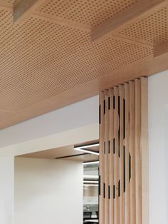 an empty room with wooden slats on the ceiling