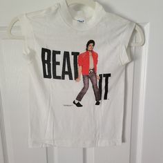 a white t - shirt with the image of michael jackson on it hanging from a door