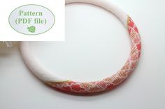 a close up of a bracelet on a white surface with the words pattern pdf file