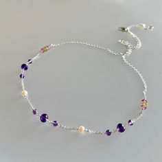 Genuine, premium-rated, mixed gemstone choker/necklace, wire wrapped in sterling silver This dainty yet colourful, all-gemstone choker/necklace, is hand-crafted with genuine, premium-rated, peridot, amethyst, pink topaz gemstones and freshwater pearls.  These gemstones are artfully positioned and meticulously wire-wrapped to create a focal segment, measuring approx. 6 inches.  A beautiful combination of coloured gemstones of purple, pink, green and creamy white pearls, with sizes ranging from 3.5 to 5.5 mm; this necklace is finished with sterling silver chain and clasp. While not quite evident in the photos, the micro-faceting and translucency of these premium-rated gemstones add much sparkle and shine to this choker/necklace.   Please note this necklace has been enlarged to show details. Dainty Natural Stone Choker Necklace, Dainty Amethyst Necklaces With Natural Stones, Dainty Sterling Silver Crystal Gemstone Necklace, Delicate Sterling Silver Wire Wrapped Necklaces, Purple Sterling Silver Necklace With Adjustable Chain, Handmade Dainty Amethyst Necklace, Dainty Sterling Silver Wire Wrapped Necklaces, Coloured Gemstones, Gemstone Choker Necklace