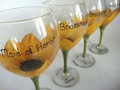 three wine glasses with sunflowers and names on them