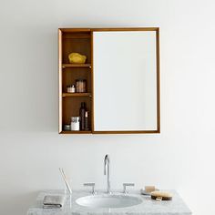 a bathroom sink with a medicine cabinet above it