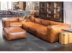 a brown leather sectional sofa in a store