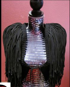 a mannequin with fringes and sequins on it's chest