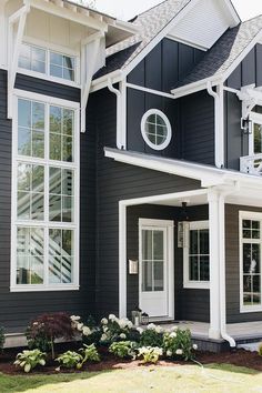 a black house with white trim and windows