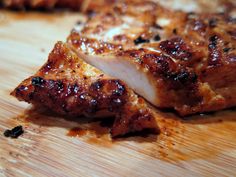 a piece of meat sitting on top of a wooden cutting board