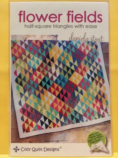 the front cover of flower fields quilt book, featuring an image of a colorful triangle design