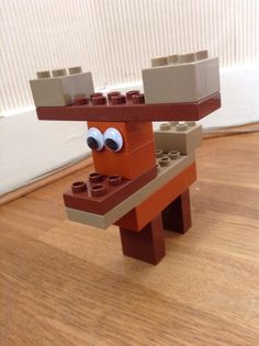 a lego dog with eyes and nose made out of bricks