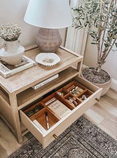 a table with drawers and a lamp on top