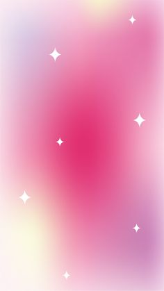 a blurry background with white stars on pink and purple hued paper in the center