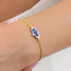 This adorable Dainty Hamsa Bracelet handcrafted by the finest artists with love and care. 18K Gold Plated Hand Of Fatima Bracelet is made from high quality 925 solid silver, 18K Gold Plated Silver Cable Chain and dark blue enamel on the hand of Fatima detail. There is a belief that the Hamsa Hand (Hand Of Fatima) protects you from all the bad luck in your life and bad energies. That's why people called it luck bracelet or protection bracelet. Sterling Silver Hamsa Bracelet is always good gift id Handmade Gold Chain Bracelet As Gift, Handmade Gold-plated Bracelet As A Gift, Handmade Yellow Gold Charm Bracelet As A Gift, Handmade Gold Plated Bracelet As Gift, Handmade Gold Plated Bracelet For Gift, Handmade Gold-plated Bracelet For Gift, Symbolic 14k Gold Bracelet For Gifts, Blue Hand-set Bracelet As A Gift, Gold Evil Eye Bangle Bracelet As Gift