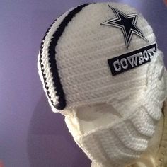 a knitted hat with the word cowboys written in black and white on it's brim