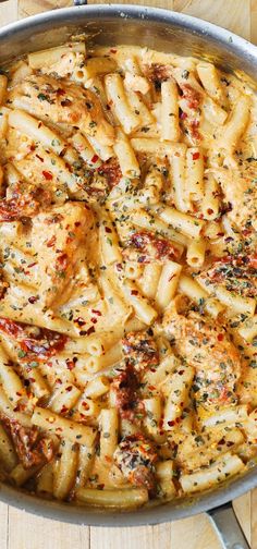 a pan filled with pasta covered in sauce and seasoning