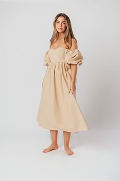 The Hamilton is everything you're looking for in a midi dress - charming, sophisticated, and absolutely flattering. It features premium quality details, like a sweetheart neckline and gorgeous balloon sleeves that can be worn on or off the shoulder. It's an unforgettable choice for every body type, and extra-comfy for expecting mamas! The best part? You can wear this beauty long after your sweet baby arrives! Available in multiple colorways. FIT: Runs true to size. Features a smocked back panel for comfort. This dress is roomy in the waist and will accommodate early maternity in your true size, but consider sizing up if you are in advanced pregnancy. MATERIAL: GARMENT DETAILS: Empire-waisted midi dress, with sweetheart neckline and statement balloon sleeves that can be worn on or off the s Summer Brunch Puff Sleeve Dress With Balloon Sleeves, Dresses With Pleated Puff Sleeves And Fitted Bodice, Puff Sleeve Dresses With Pleated Sleeves And Fitted Bodice, Summer Off-shoulder Voluminous Dress, Dresses With Elastic Puff Sleeves And Fitted Bodice, Puff Sleeve Dresses With Elastic Sleeves And Fitted Bodice, Fitted Bodice Dress With Elastic Puff Sleeves, Voluminous Dresses For Summer Garden Party, Chic Off-shoulder Voluminous Dresses