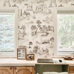 a kitchen with a lot of wallpaper on the walls