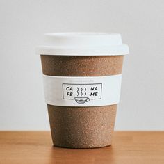 a coffee cup sitting on top of a wooden table