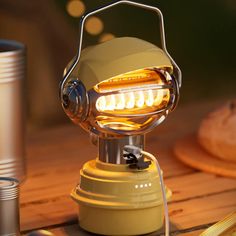 a yellow light sitting on top of a wooden table